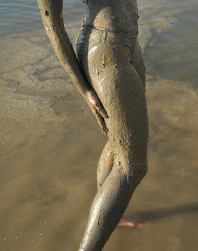 half naked woman add dead sea clay