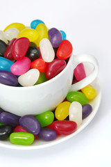 Cup of jelly beans, isolated on white.