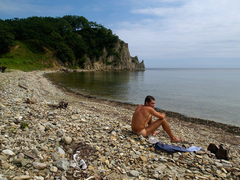 Naked Man On The Wild Beach