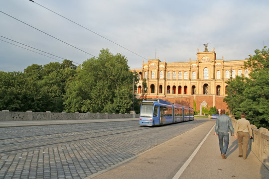 A streetcar (and a couple) on a bridge in Munich