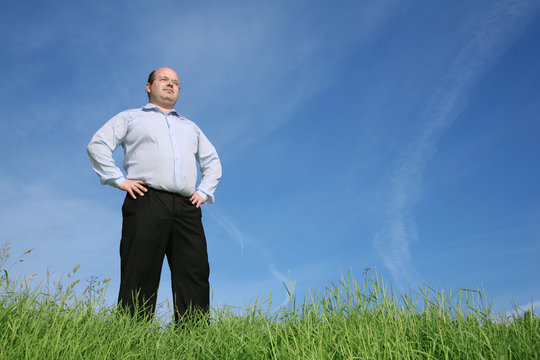 fat man standing on the meaow