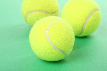 tennis balls with green background
