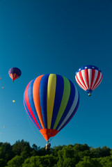 Hot Air Balloonsw ascending into a clear blue vermont sky
