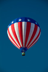 Red White and Blue Hot Air Balloon in cloudless blue sky