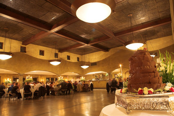 Layered chocolate wedding cake on a silver platter 