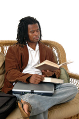 a young man in a waiting area reading a book