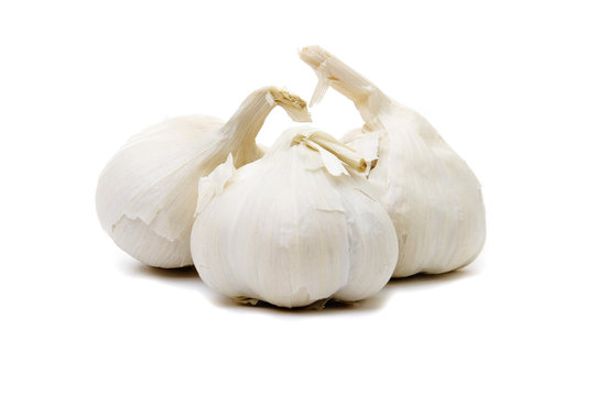 Three whole garlic bulbs on a white background