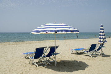 Empty chairs on the beach ready for you