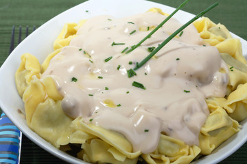 a plate of italian pasta with mushroom cream sauce