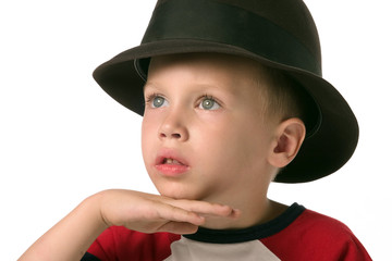 a boy with hat is posing