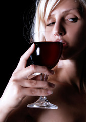girl is looking beside and drinking wine