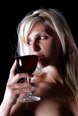girl is standing and holding wine