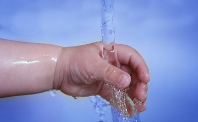 Life! Baby hand and running water