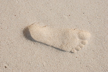 Footprint on sandy beach