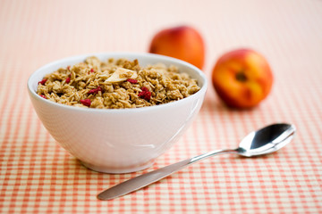 Breakfast cereal with dryed fruits and fresh peaches