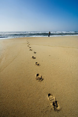 a man walking on the beach 
