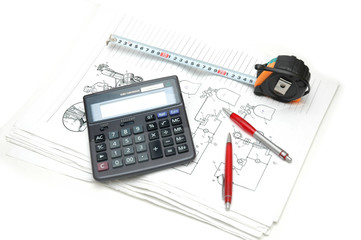 Calculator and pencils over the  engineering drawings