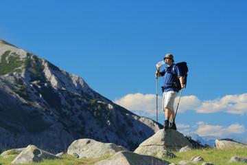 Backpacker standing on a rock in national park Pirin, Bulgaria