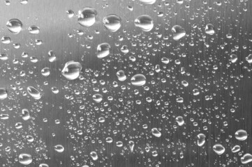 Brushed steel with water droplets on.