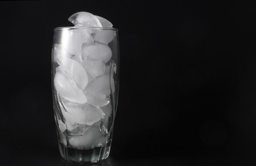 Ice cubes in a clear water glass.
