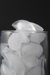Ice cubes in a clear water glass.