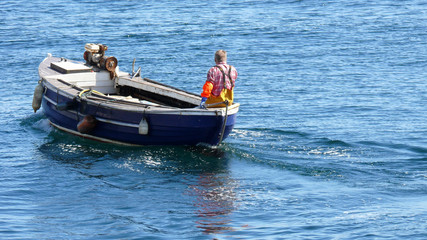 Obraz premium Fisherman on small boat