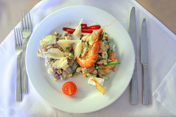 Salad with the shrimp and parmesan in restaurant