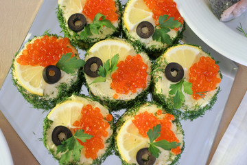 Sandwiches with caviar, olive and lemon