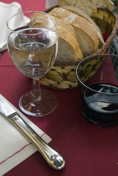 Wine, bread, glasses in a table setting  of a restaurant
