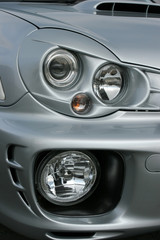 Obraz na płótnie Canvas Headlights and side lights on a silver metallic car