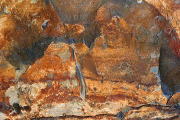 Natural slate with shades of red, brown, gold and black.