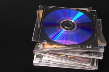 A stack of compact discs with recorded music.