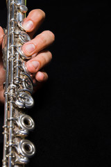 Fototapeta premium Flute in hands - music background. Classic music concert concept