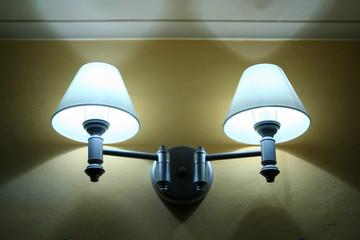 A pair of room lamp lit during the evening