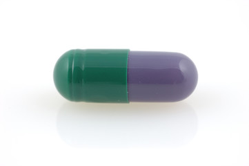 Green and grey capsule with reflection