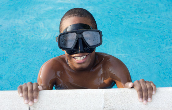 Black boy with glasses in the swimming pool