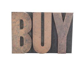 the word 'BUY' in old wood letters