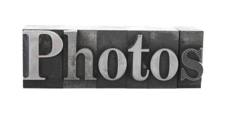 the word 'photos' in old, inkstained metal type