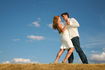 couple dancing on the meadow