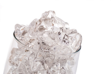 Random ice chunks on a glass on white background