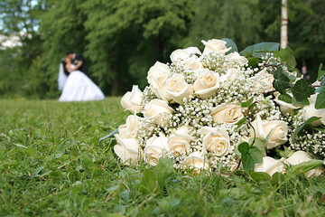 Wedding boquete and married couple behind