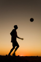 Naklejka premium football at sunset