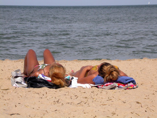 two women sunbathing at virginia beach
