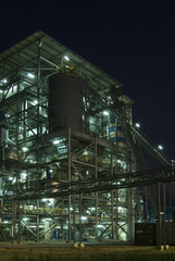 Industrial processing plant at night with lights