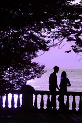lovers on the beach at violet sunset (sunrise)