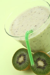 glass of fresh kiwi smoothie and some fresh fruits