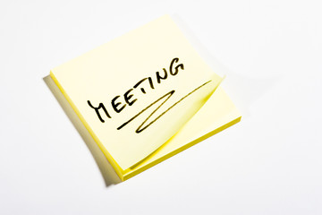 Yellow Post-It with MEETING - on white background