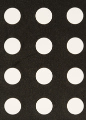 a pattern of white holes in a black texture