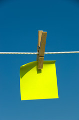 Yellow sticky note on a clothesline