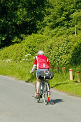 Naklejka premium cyclists cycling along road